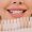 cropped view of smiling woman holding teeth color palette, teeth whitening concept