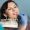 Close-up portrait of woman in dental clinic office. Dentist checking and selecting colour of the teeth, making the process of treatment. Dentistry